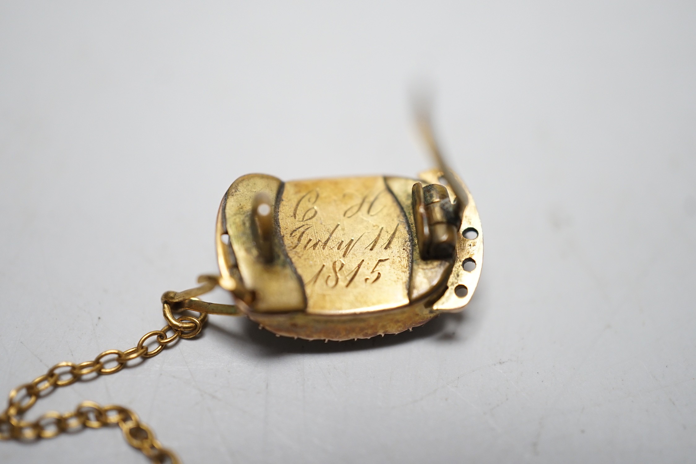 A George III yellow metal and plated hair mourning brooch, engraved 'BH, July 11th, 1815', 16mm, (ex clasp, now mounted as a brooch).